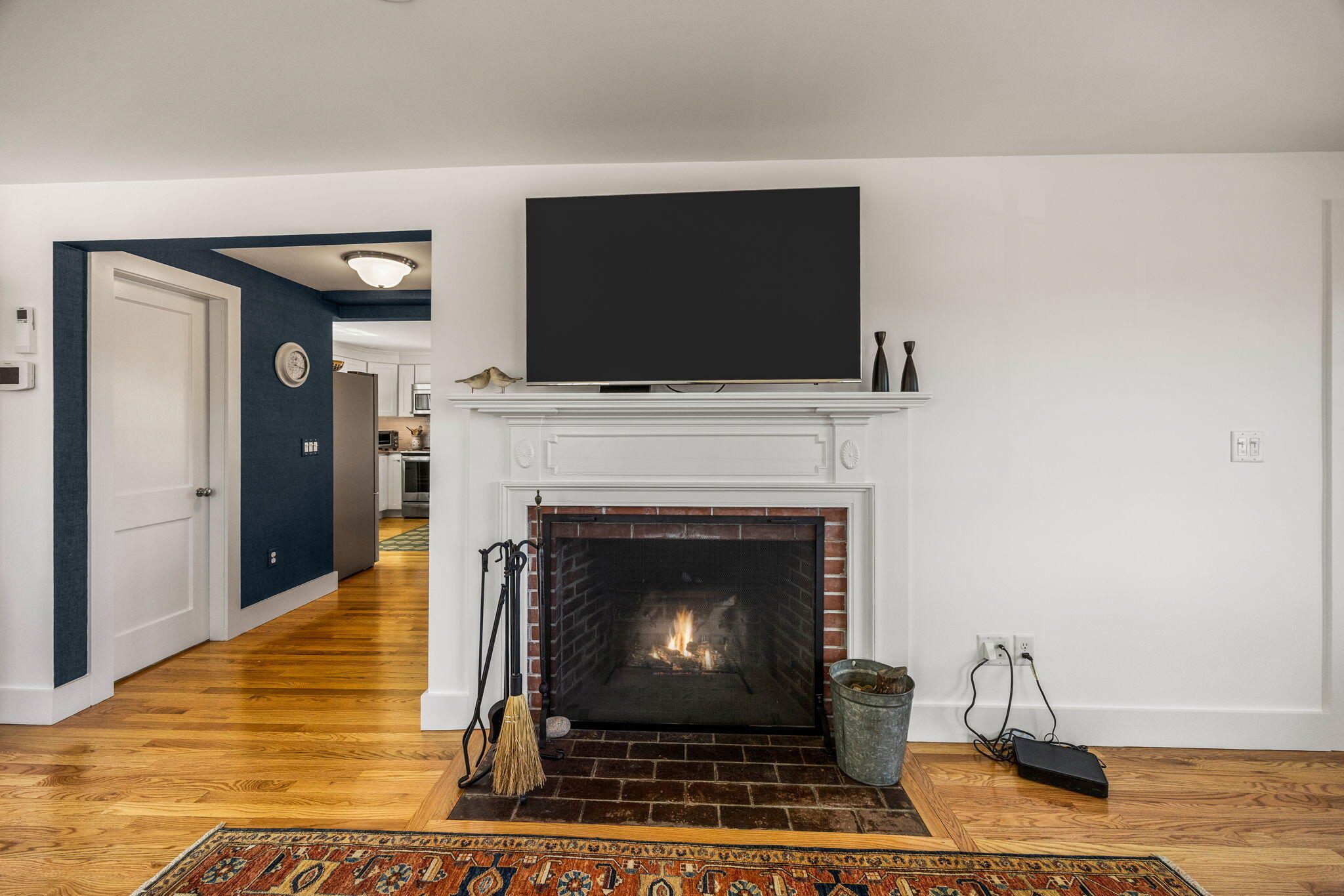 58 Stepping Stones Road Chatham, MA 02633 - Photo 18 of 52 a living room with a fireplace and a flat screen tv
