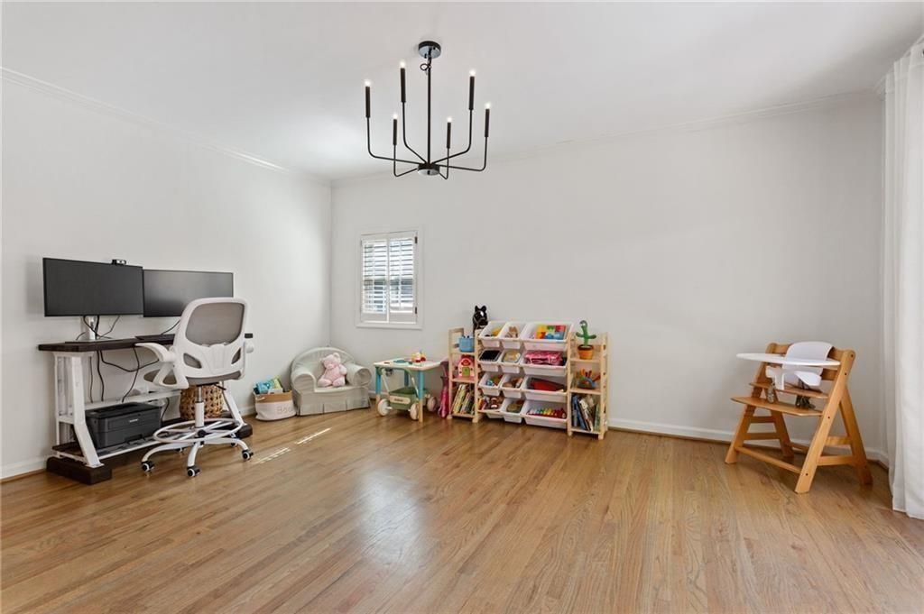 2624 Peeler Road Atlanta, GA 30360 - Photo 16 of 46 a bedroom with furniture and a wooden floor