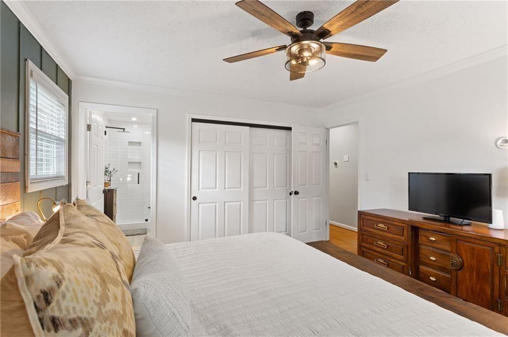 2624 Peeler Road Atlanta, GA 30360 - Photo 21 of 46 a bedroom with a bed and a flat screen tv