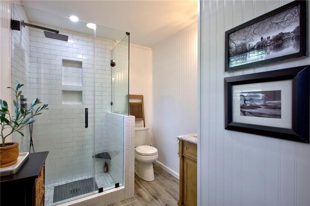 2624 Peeler Road Atlanta, GA 30360 - Photo 22 of 46 a bathroom with a picture of a shower and a toilet