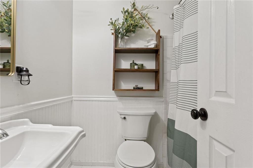 2624 Peeler Road Atlanta, GA 30360 - Photo 31 of 46 a bathroom with a toilet sink and mirror