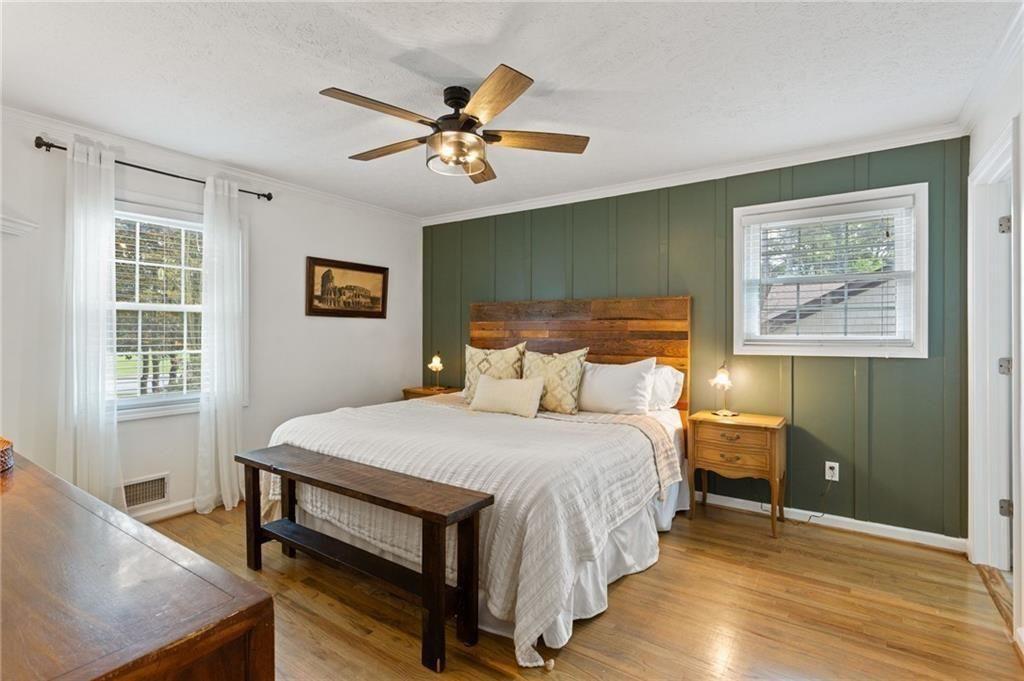 2624 Peeler Road Atlanta, GA 30360 - Photo 4 of 46 a bedroom with a bed and a chandelier