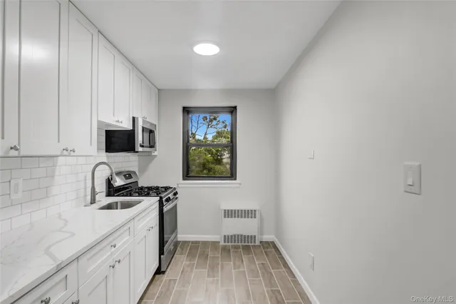 a view of a kitchen with a sink and a window
