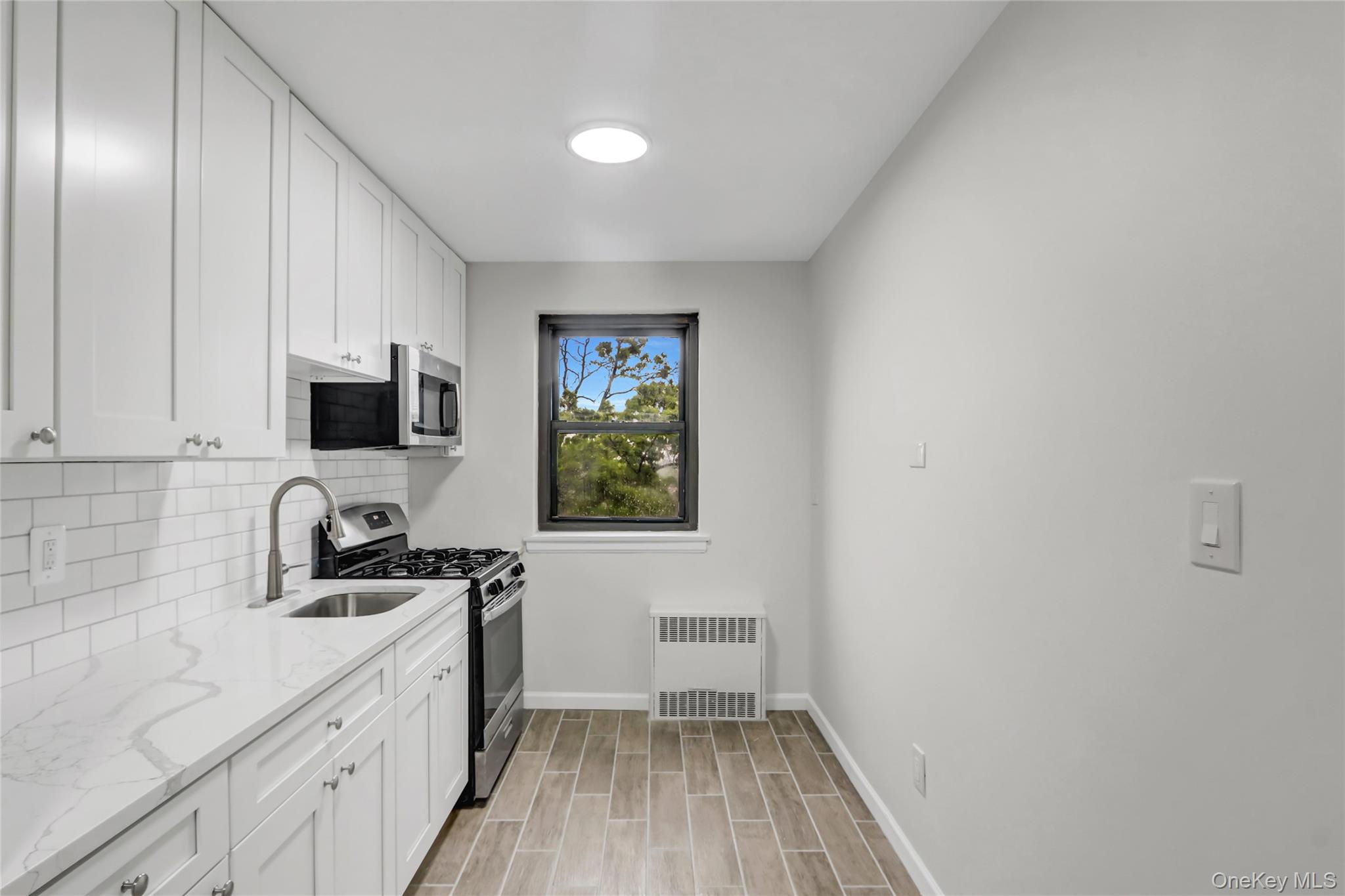 204-15 Foothill Avenue, Unit B53 Queens, NY 11427 - Photo 11 of 18 a view of a kitchen with a sink and a window