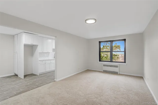 an empty room with a empty space and windows