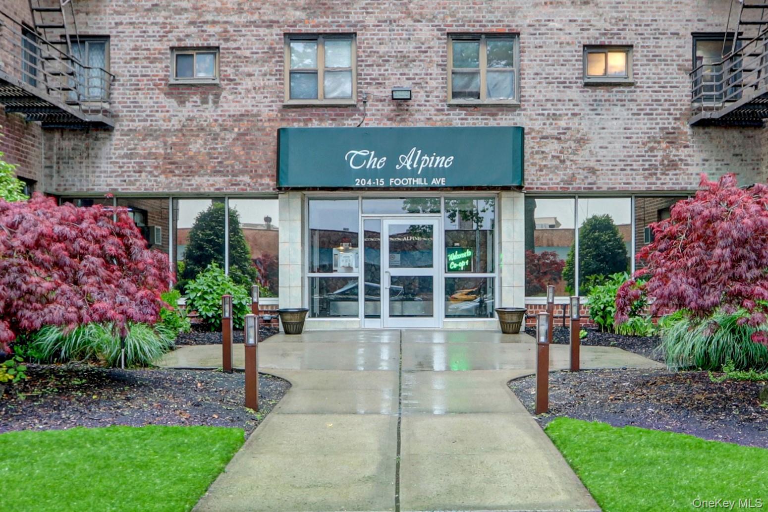 204-15 Foothill Avenue, Unit B53 Queens, NY 11427 - Photo 2 of 18 a front view of a multi story building with yard