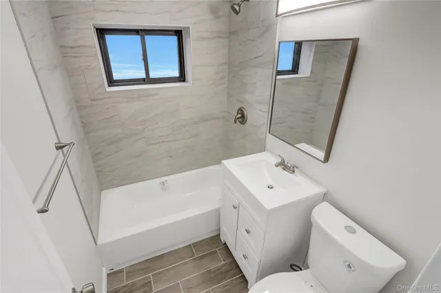 a bathroom with a sink toilet and bath tub