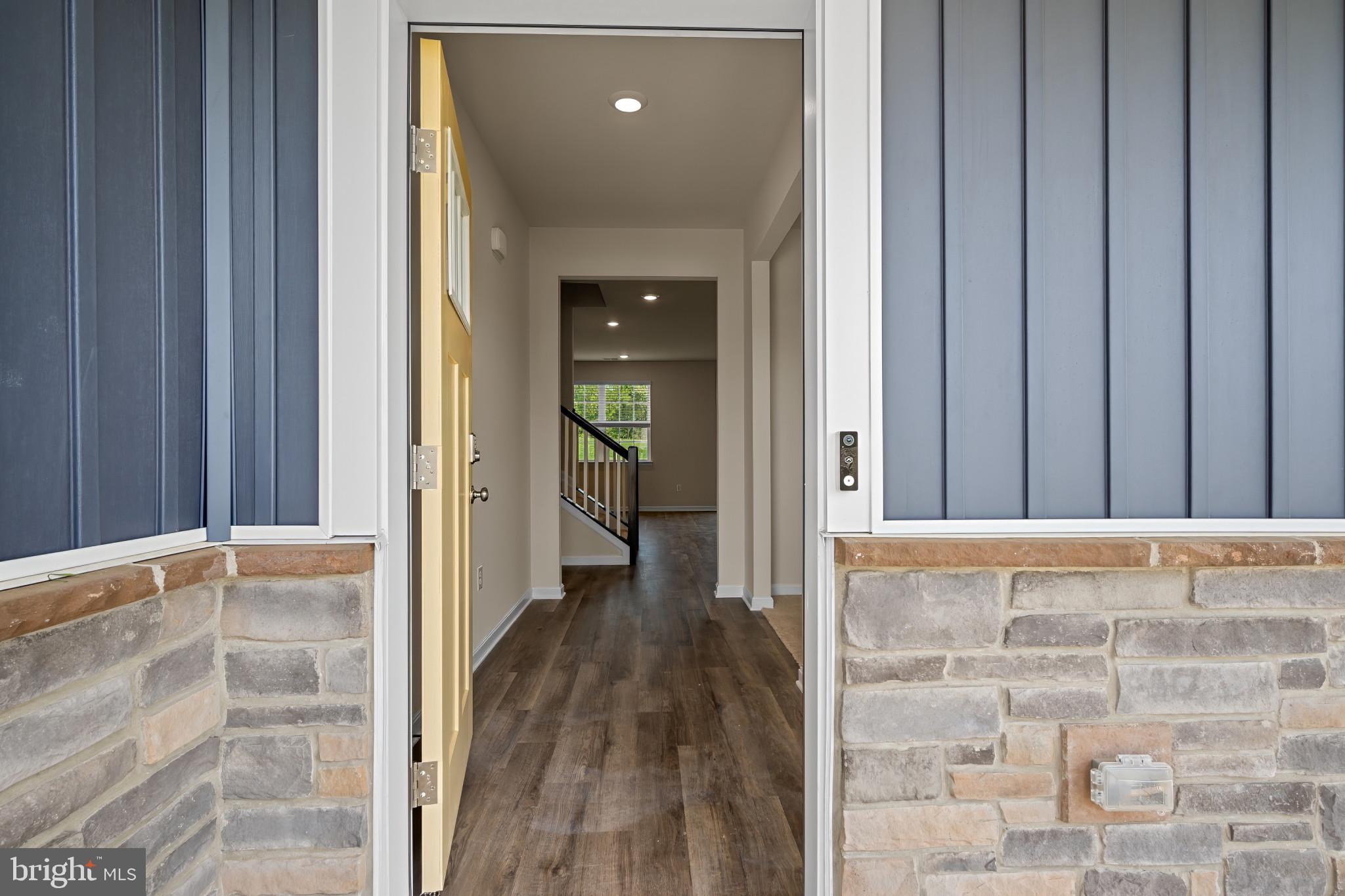 547 Atkinson Street Charles Town, WV 25414 - Photo 3 of 31 a view of a hallway with wooden floor and a bathroom