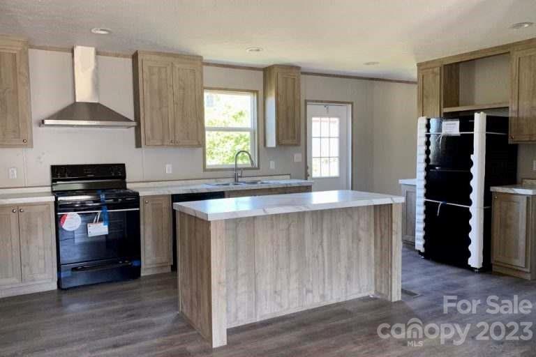 2550 Saluda Road Chester, SC 29706 - Photo 5 of 6 a kitchen with kitchen island granite countertop a stove a sink and a refrigerator