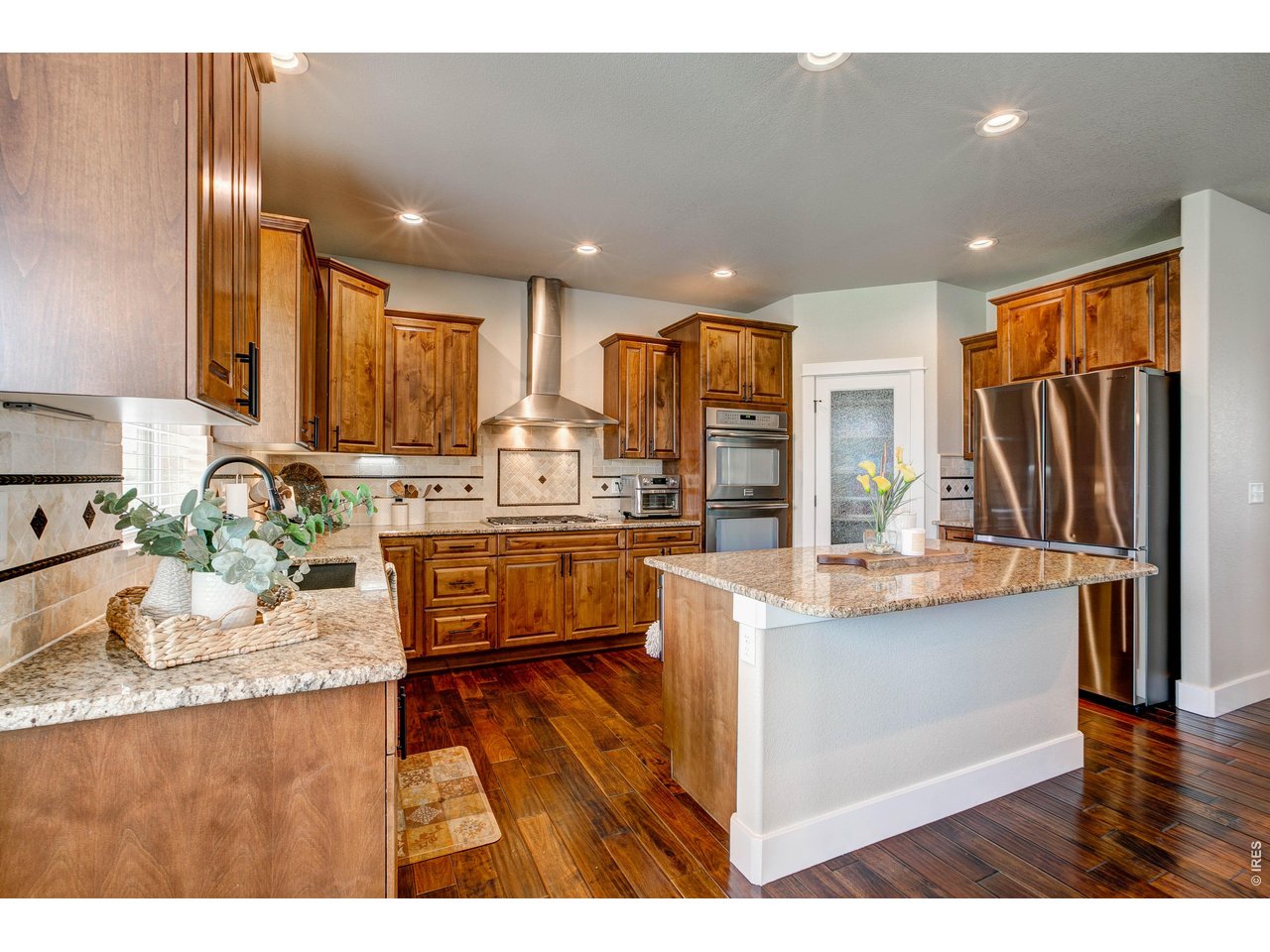 39764 Ridge Park Drive Severance, CO 80610 - Photo 18 of 49 Loads of cabinets and counter areas in this luxury kitchen!