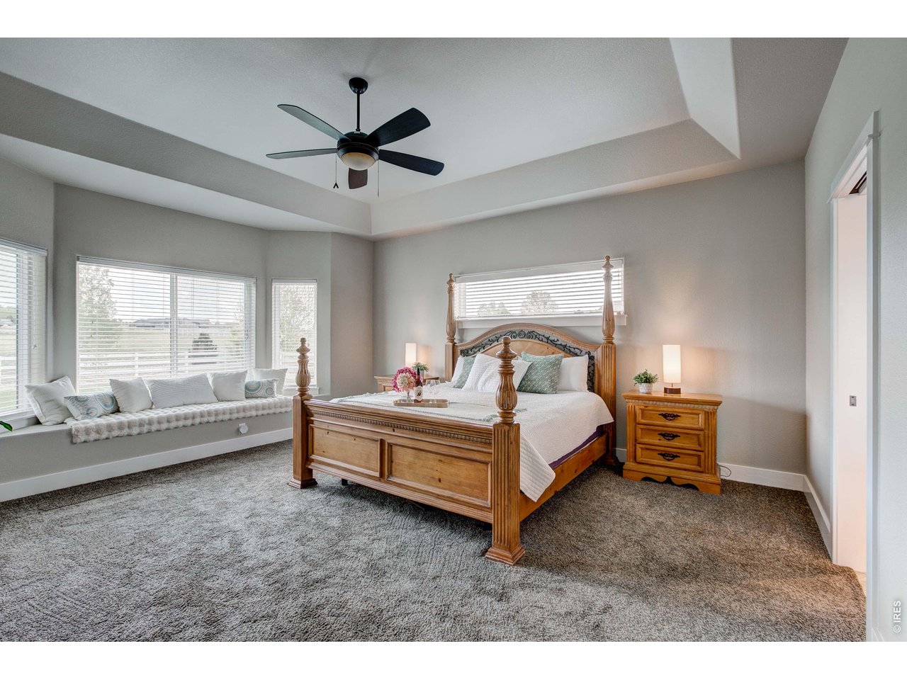 39764 Ridge Park Drive Severance, CO 80610 - Photo 24 of 49 Main Level Primary Suite with elegant ceiling detail and large bay window with built-in bench seating and storage.