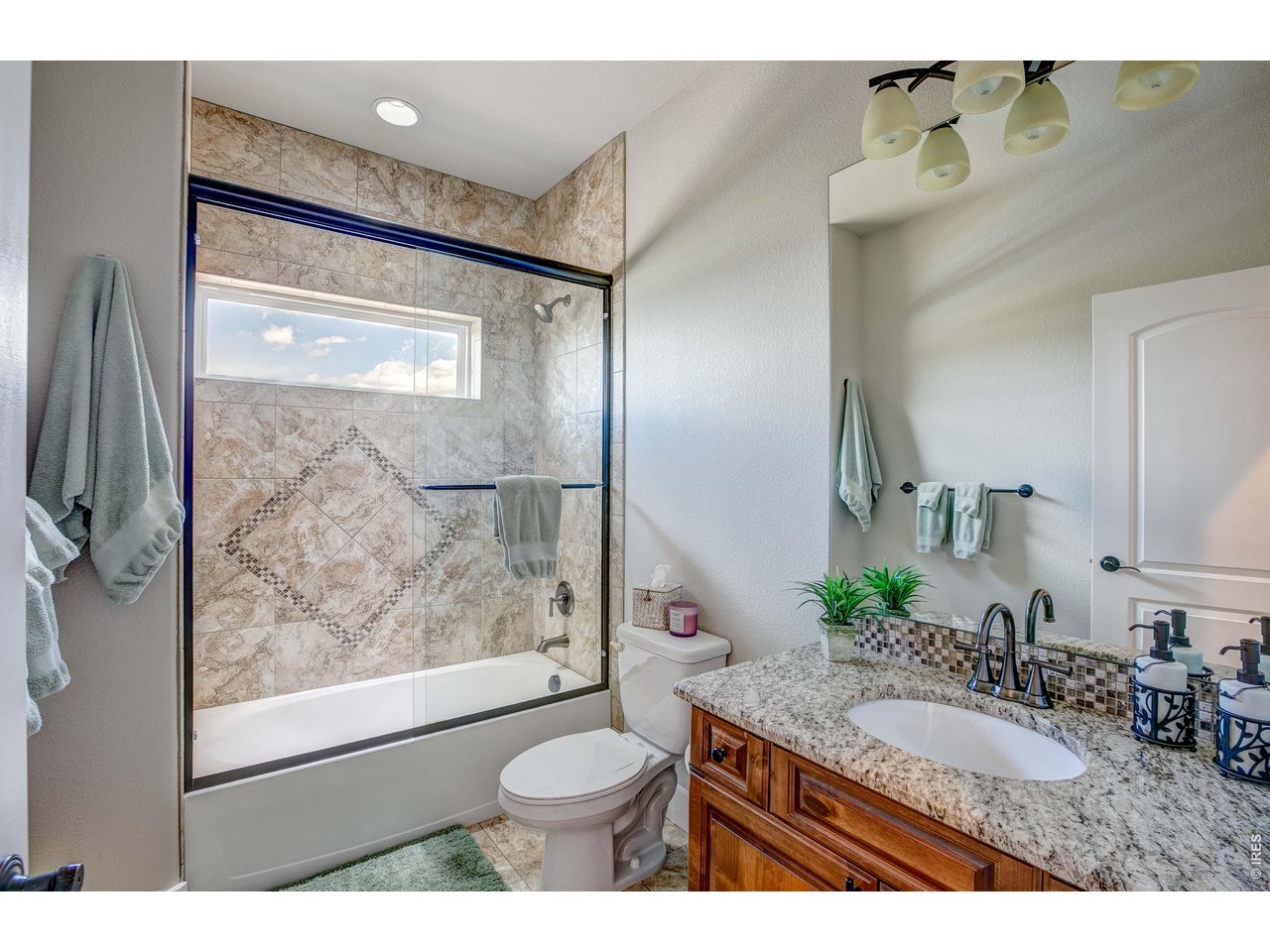 39764 Ridge Park Drive Severance, CO 80610 - Photo 29 of 49 Main Level Guest Bathroom located between the 2 guest Bedrooms. Granite counter and custom tile shower surround.
