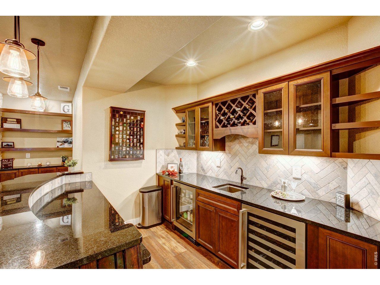 39764 Ridge Park Drive Severance, CO 80610 - Photo 39 of 49 Party On! Step right up to this Custom Bar with sink, wine fridge and beverage fridge included! The granite counters and full backsplash add to the elegance.