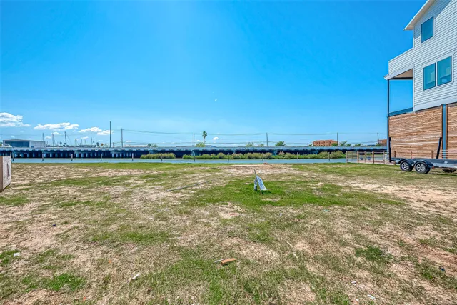a swimming pool with outdoor seating and yard