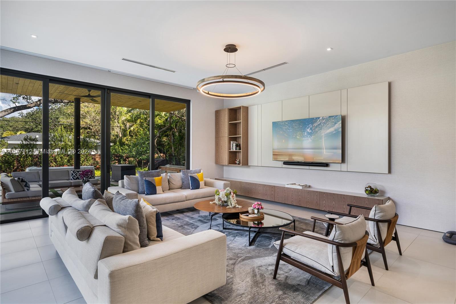 7825 Southwest 128th Street Pinecrest, FL 33156 - Photo 12 of 40 a living room with furniture and a large window
