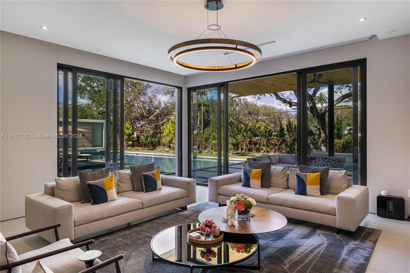 7825 Southwest 128th Street Pinecrest, FL 33156 - Photo 14 of 40 a living room with furniture and a large window