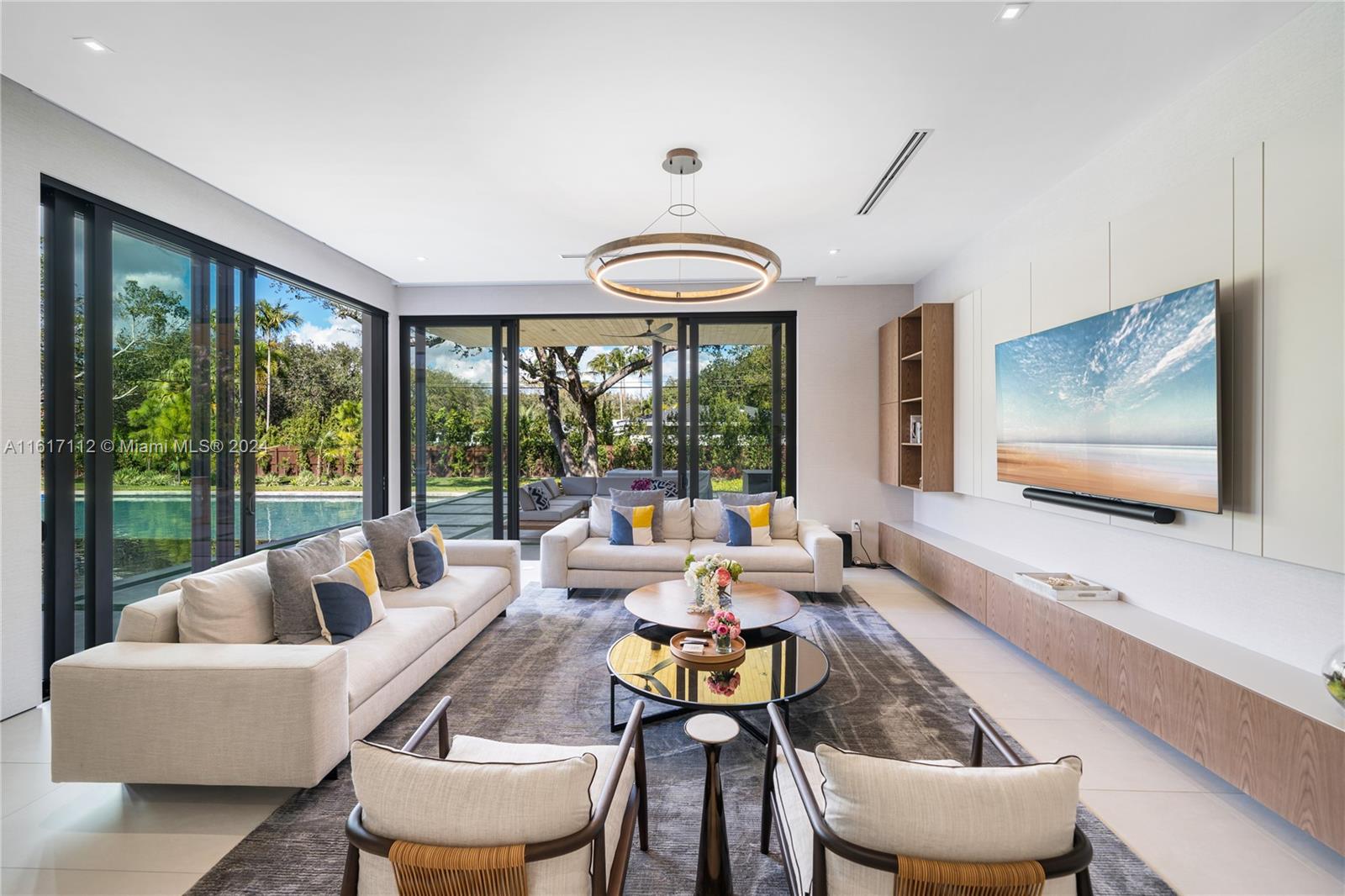 7825 Southwest 128th Street Pinecrest, FL 33156 - Photo 15 of 40 a living room with furniture and a large window