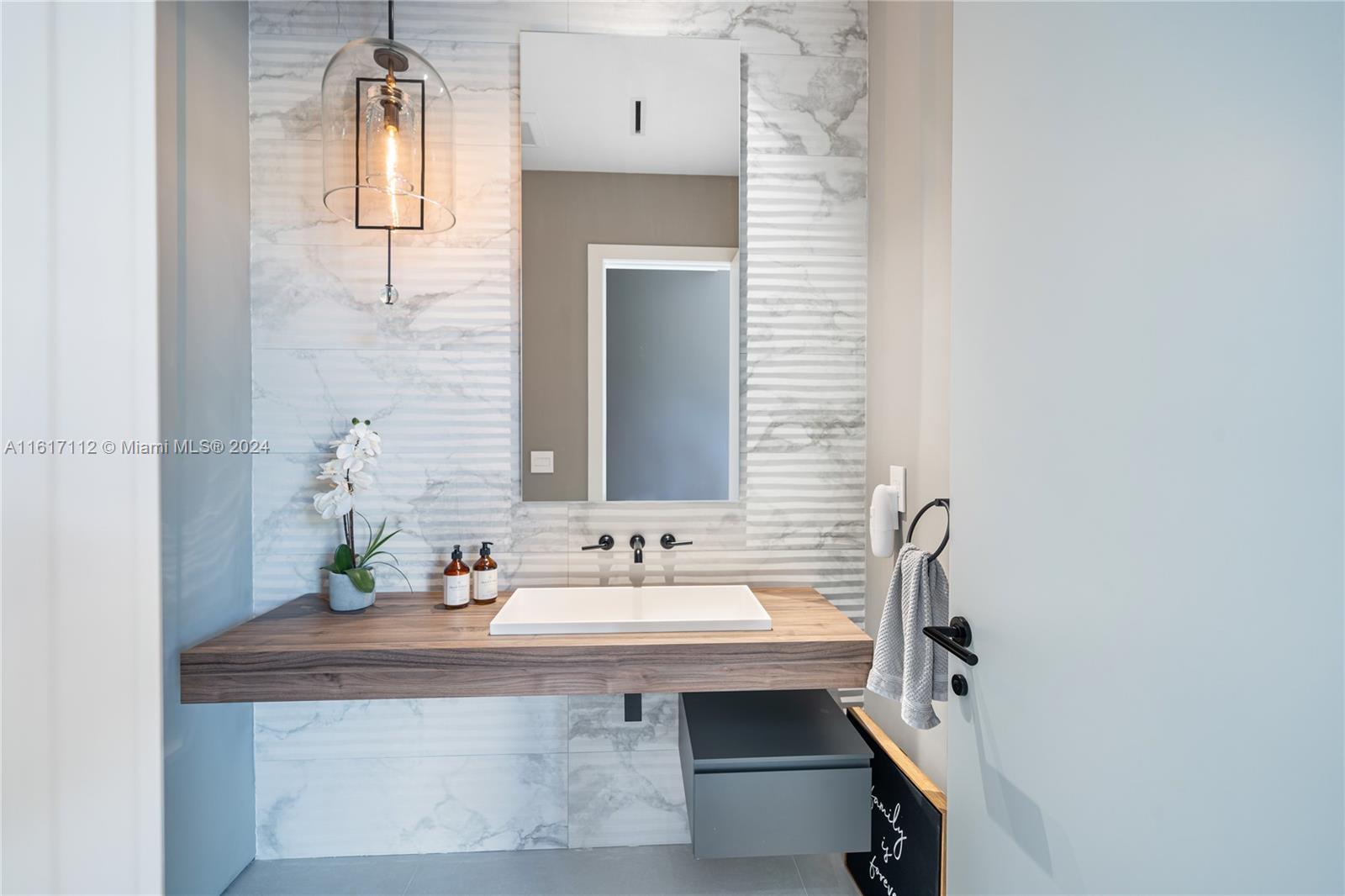 7825 Southwest 128th Street Pinecrest, FL 33156 - Photo 16 of 40 a bathroom with a sink and a mirror