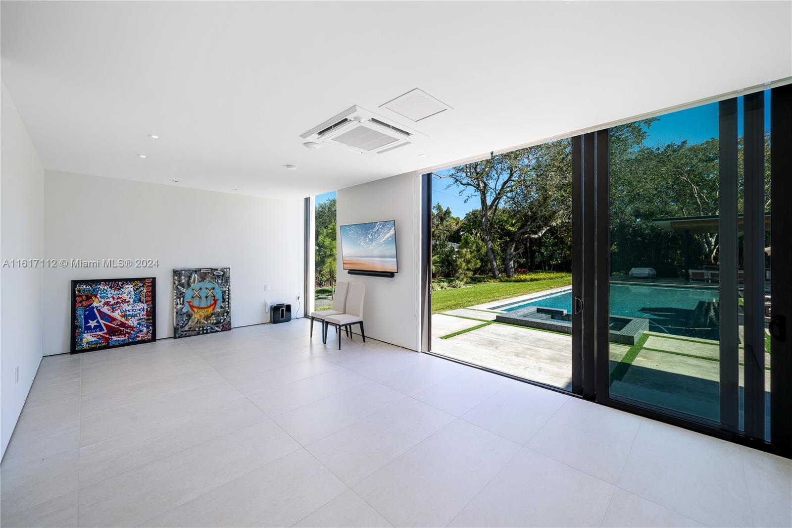 7825 Southwest 128th Street Pinecrest, FL 33156 - Photo 17 of 40 a view of a livingroom with furniture outside view and a large window