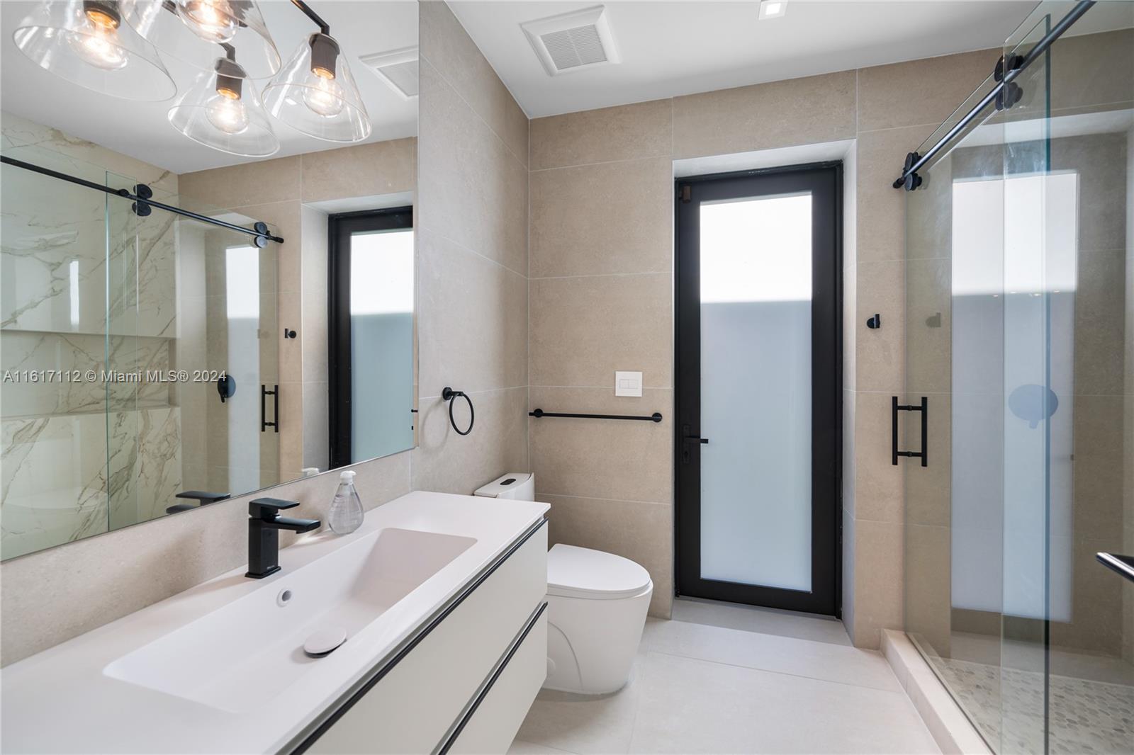 7825 Southwest 128th Street Pinecrest, FL 33156 - Photo 18 of 40 a bathroom with a sink a toilet and shower