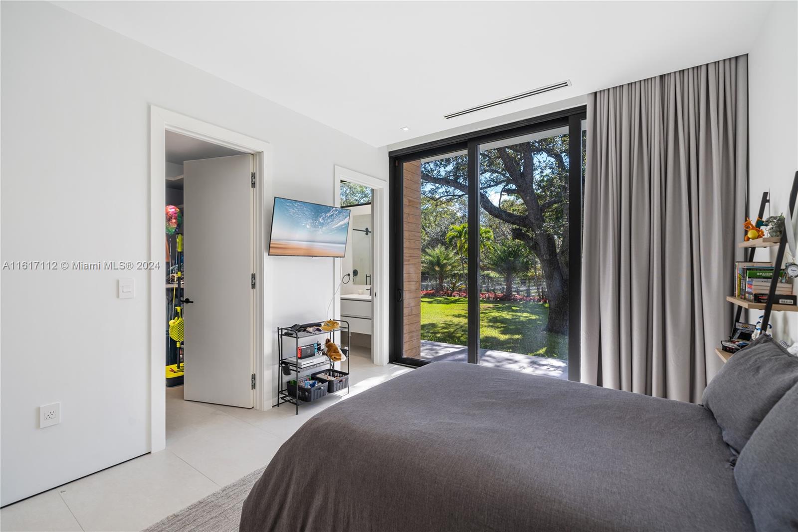 7825 Southwest 128th Street Pinecrest, FL 33156 - Photo 21 of 40 a view of a bedroom with furniture and a large window