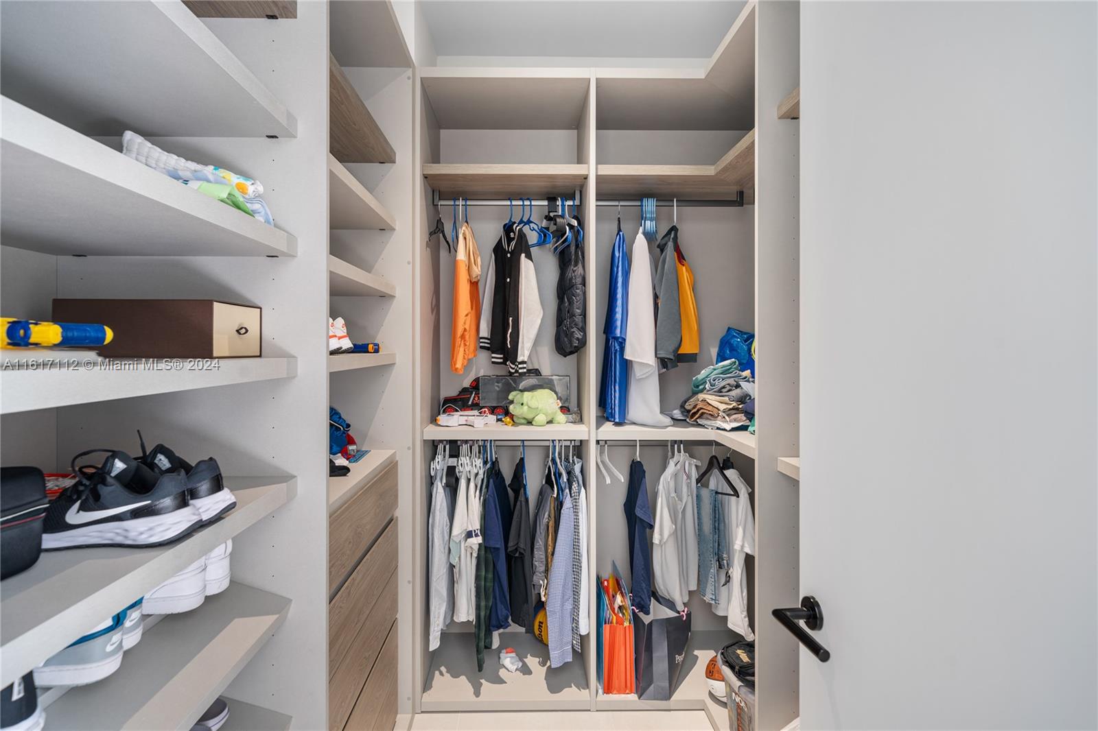 7825 Southwest 128th Street Pinecrest, FL 33156 - Photo 22 of 40 a view of walk in closet with clothes and shoes