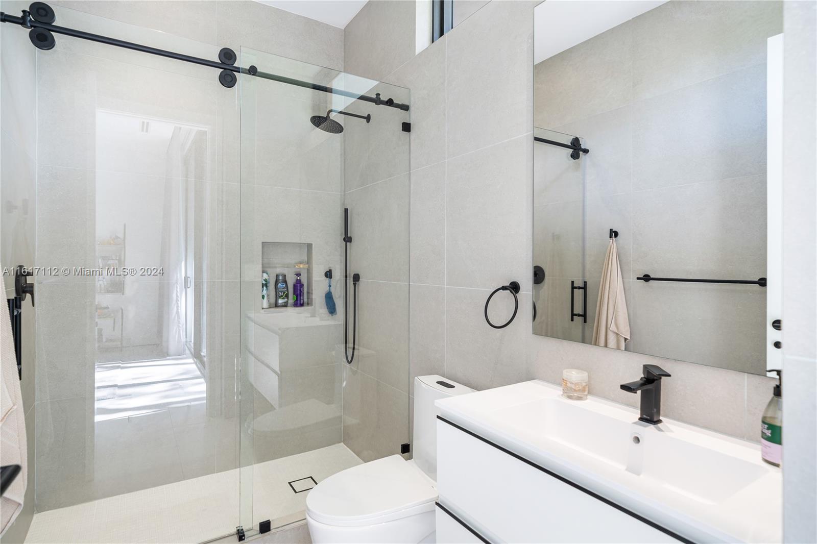 7825 Southwest 128th Street Pinecrest, FL 33156 - Photo 23 of 40 a bathroom with a sink toilet tub and shower