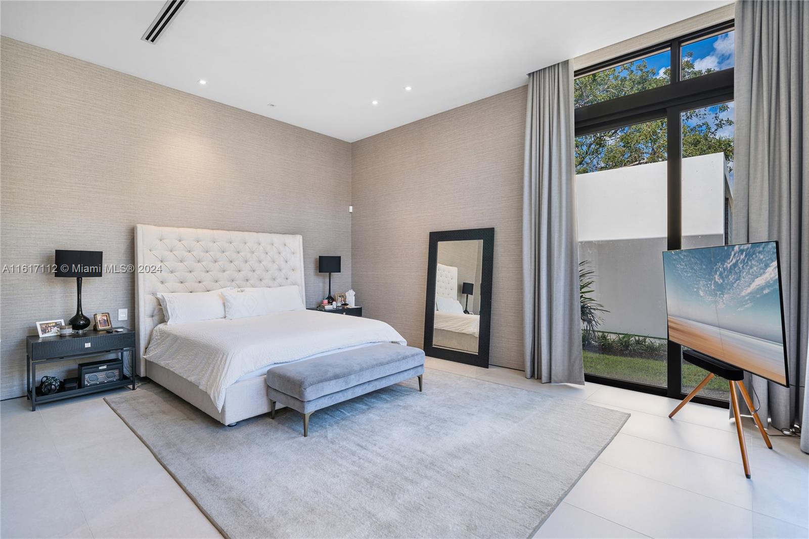 7825 Southwest 128th Street Pinecrest, FL 33156 - Photo 24 of 40 a bedroom with a large bed and a window