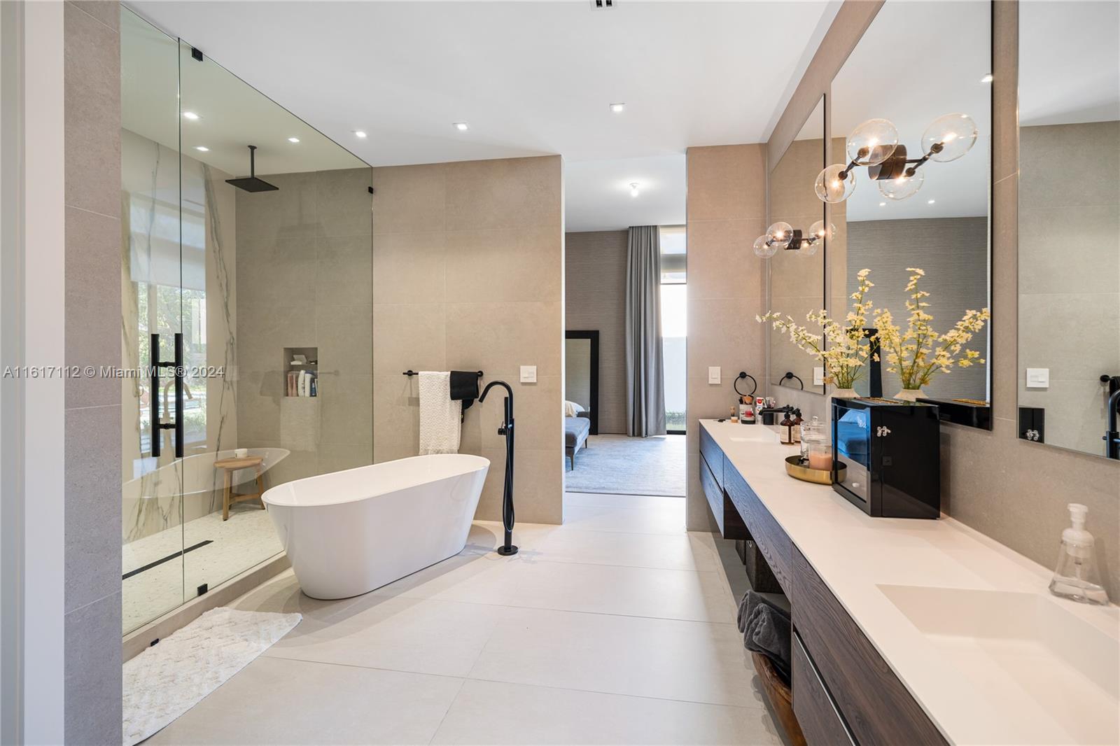 7825 Southwest 128th Street Pinecrest, FL 33156 - Photo 28 of 40 a large spacious bathroom with a tub sink shower and mirror