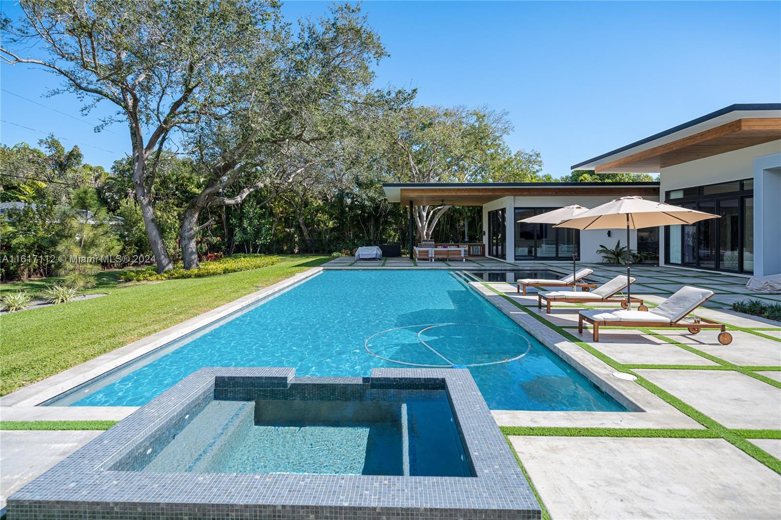 7825 Southwest 128th Street Pinecrest, FL 33156 - Photo 33 of 40 a view of swimming pool with chairs and tables