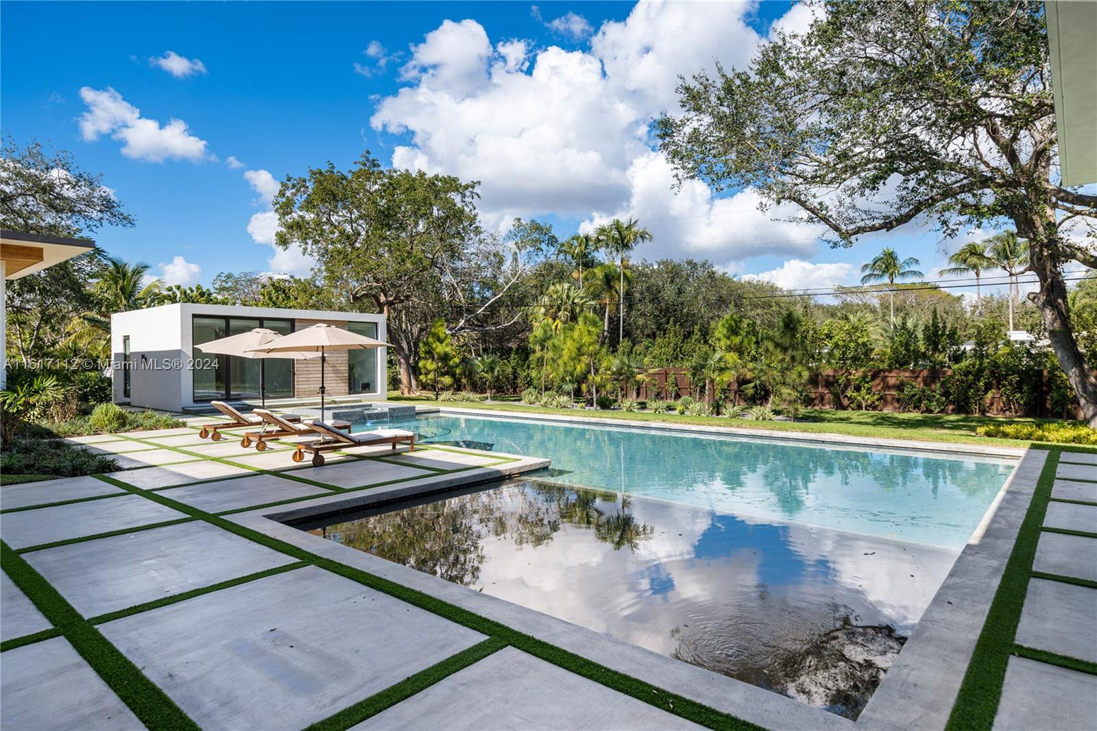 7825 Southwest 128th Street Pinecrest, FL 33156 - Photo 35 of 40 a view of a swimming pool with chairs