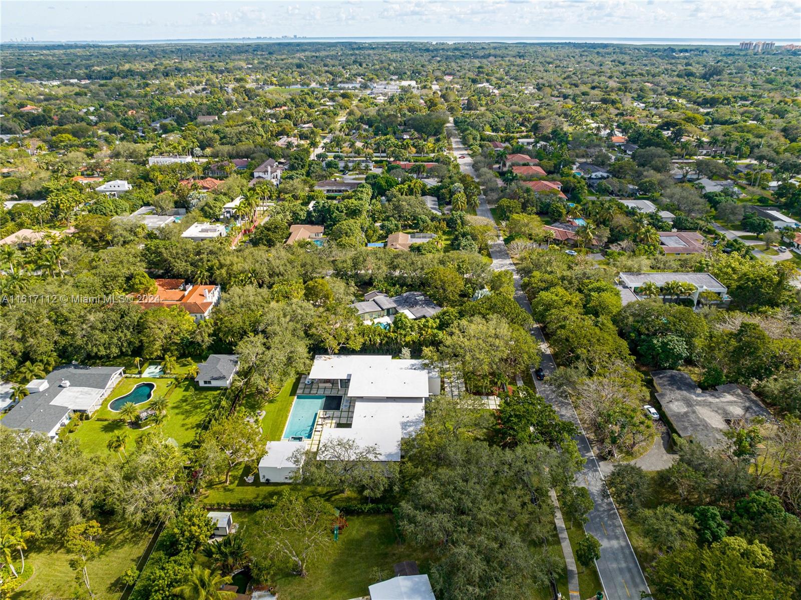 7825 Southwest 128th Street Pinecrest, FL 33156 - Photo 40 of 40 an aerial view of residential houses with outdoor space and trees