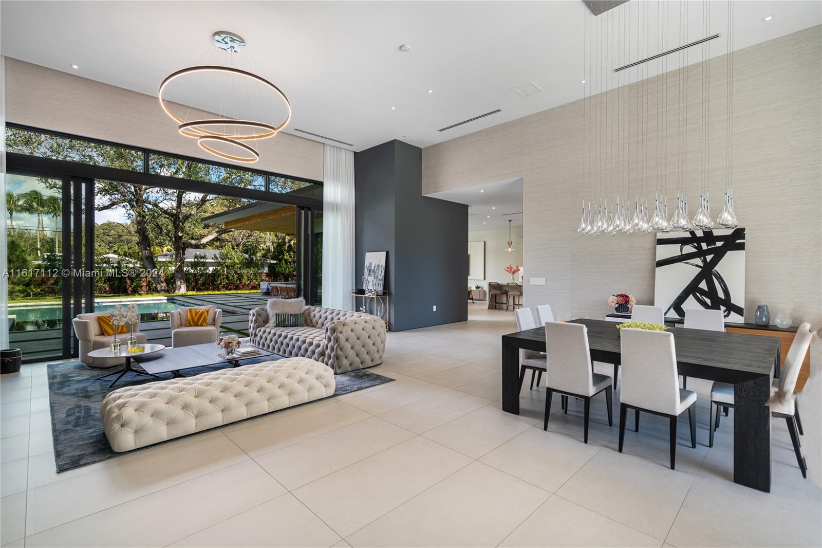 7825 Southwest 128th Street Pinecrest, FL 33156 - Photo 6 of 40 a living room with furniture and a large window