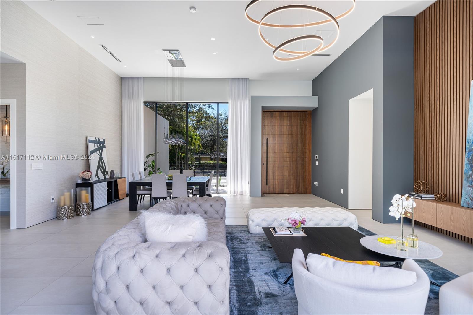 7825 Southwest 128th Street Pinecrest, FL 33156 - Photo 7 of 40 a living room with furniture and a large window