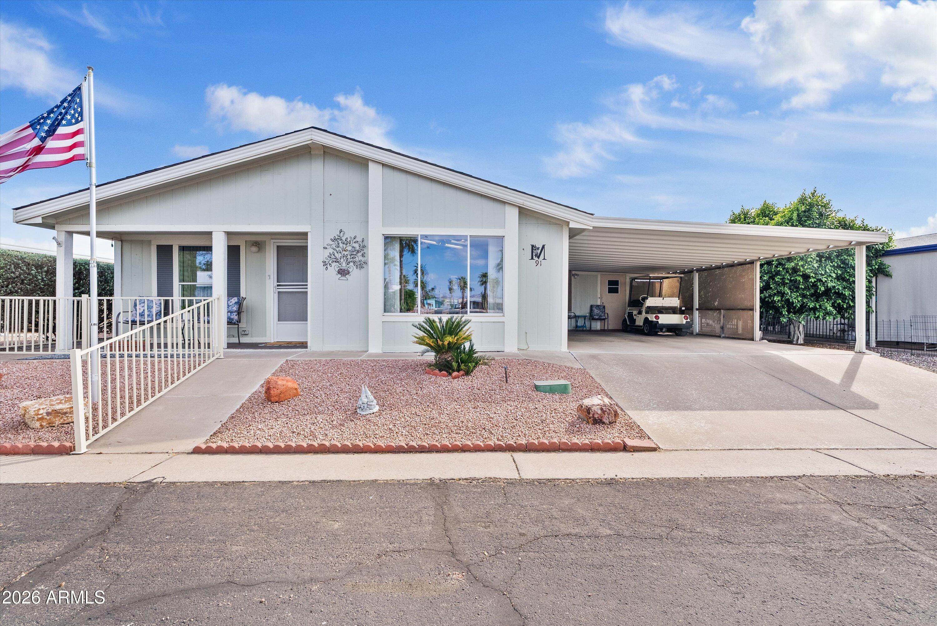 3700 South Tomahawk Road, Unit 91 Apache Junction, AZ 85119 - Photo 2 of 29 a view of a house with a patio