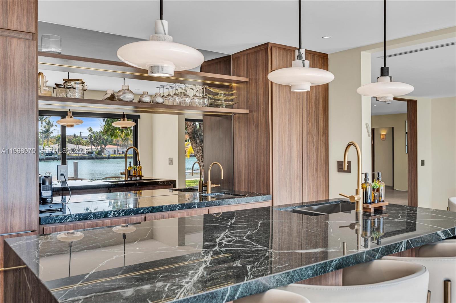 a large kitchen with stainless steel appliances kitchen island granite countertop a table and chairs in it