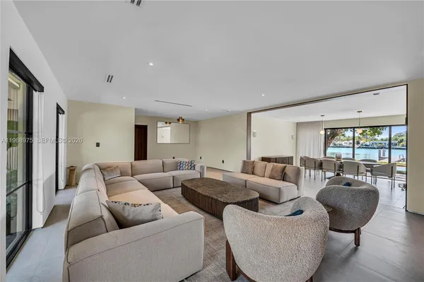 a living room with furniture and large windows