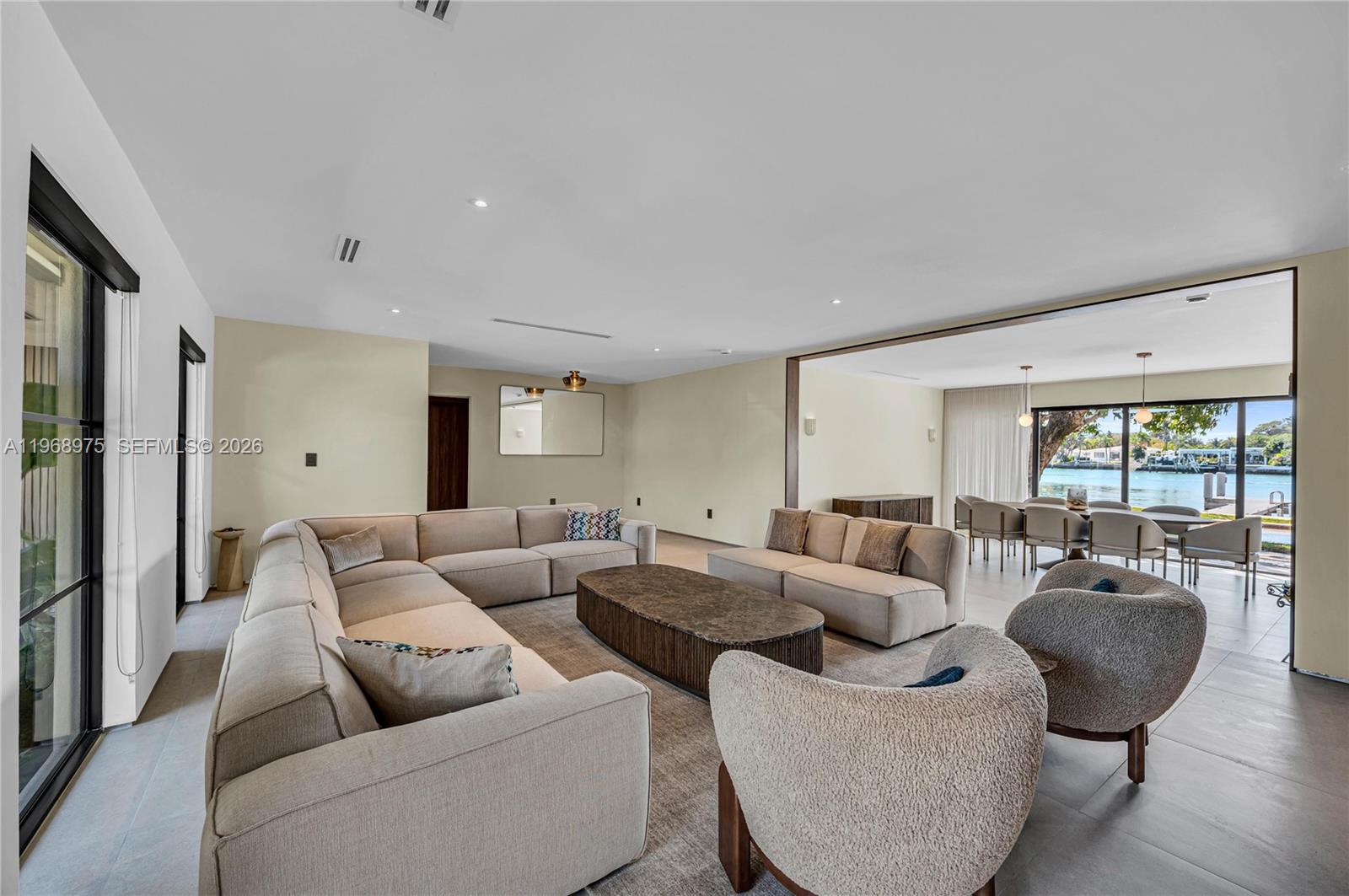 1170 South Biscayne Point Road Miami Beach, FL 33141 - Photo 12 of 48 a living room with furniture and large windows