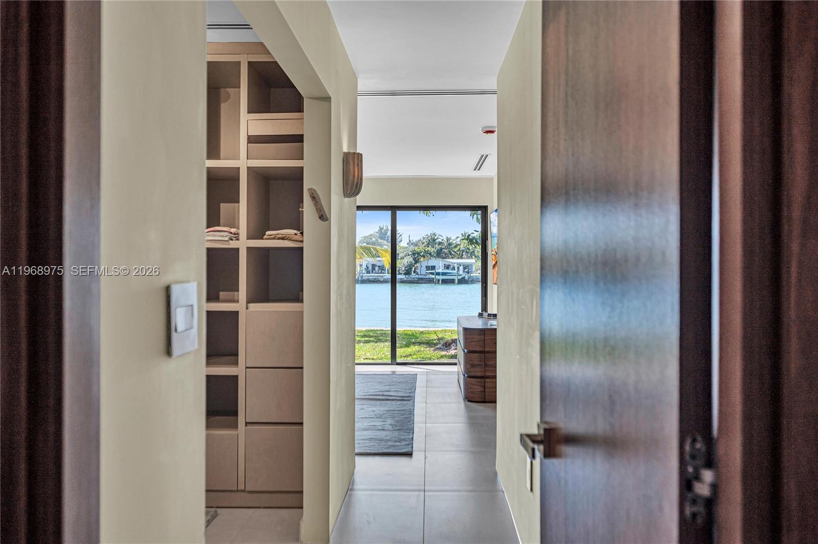 1170 South Biscayne Point Road Miami Beach, FL 33141 - Photo 19 of 48 a view of empty room with wooden floor and floor to ceiling window