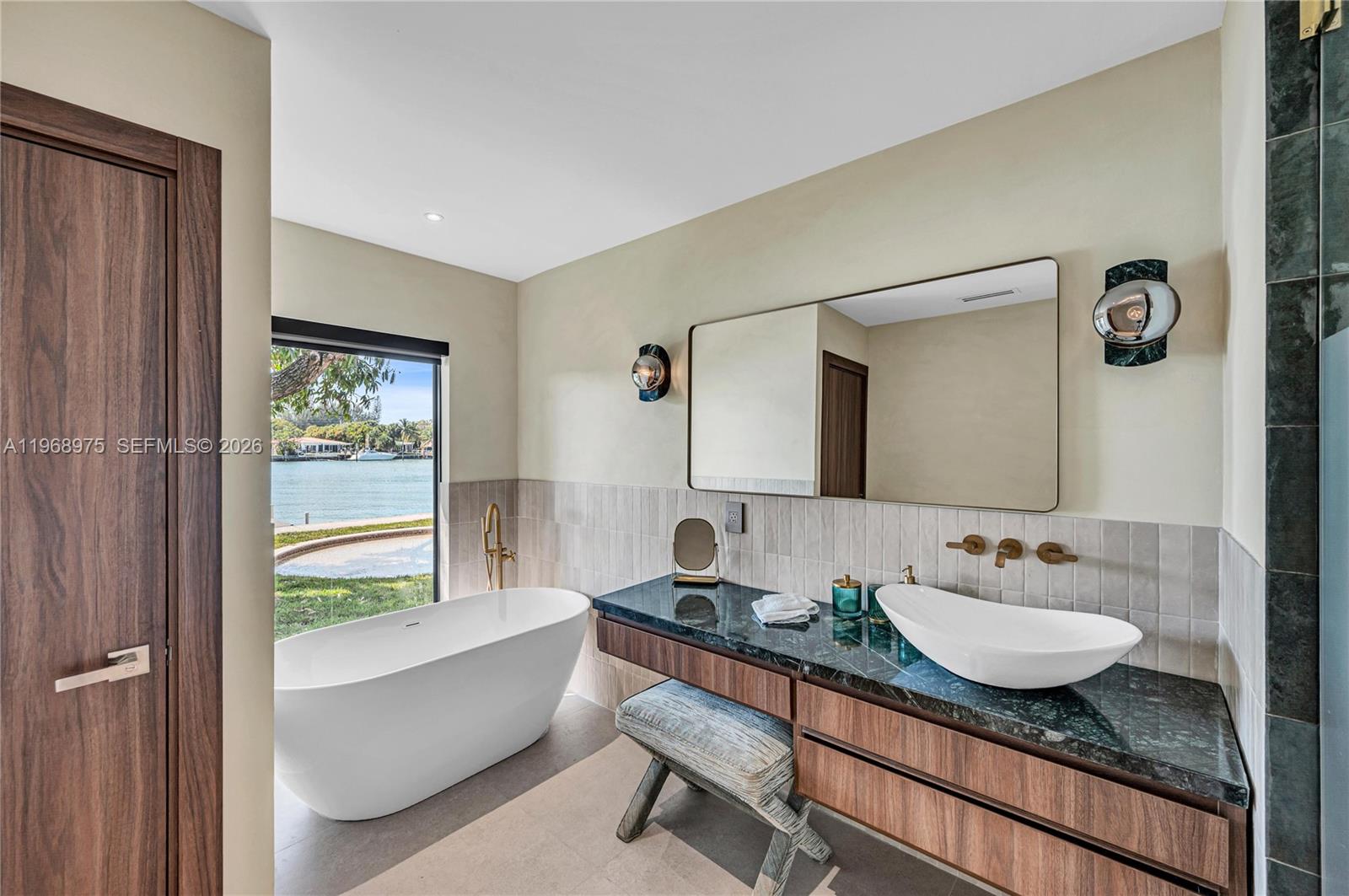 1170 South Biscayne Point Road Miami Beach, FL 33141 - Photo 23 of 48 a bathroom with a granite countertop sink and a mirror