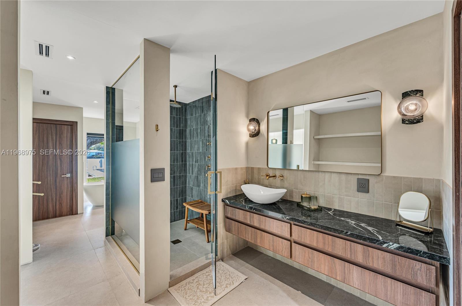 1170 South Biscayne Point Road Miami Beach, FL 33141 - Photo 25 of 48 a spacious bathroom with a granite countertop sink and a mirror