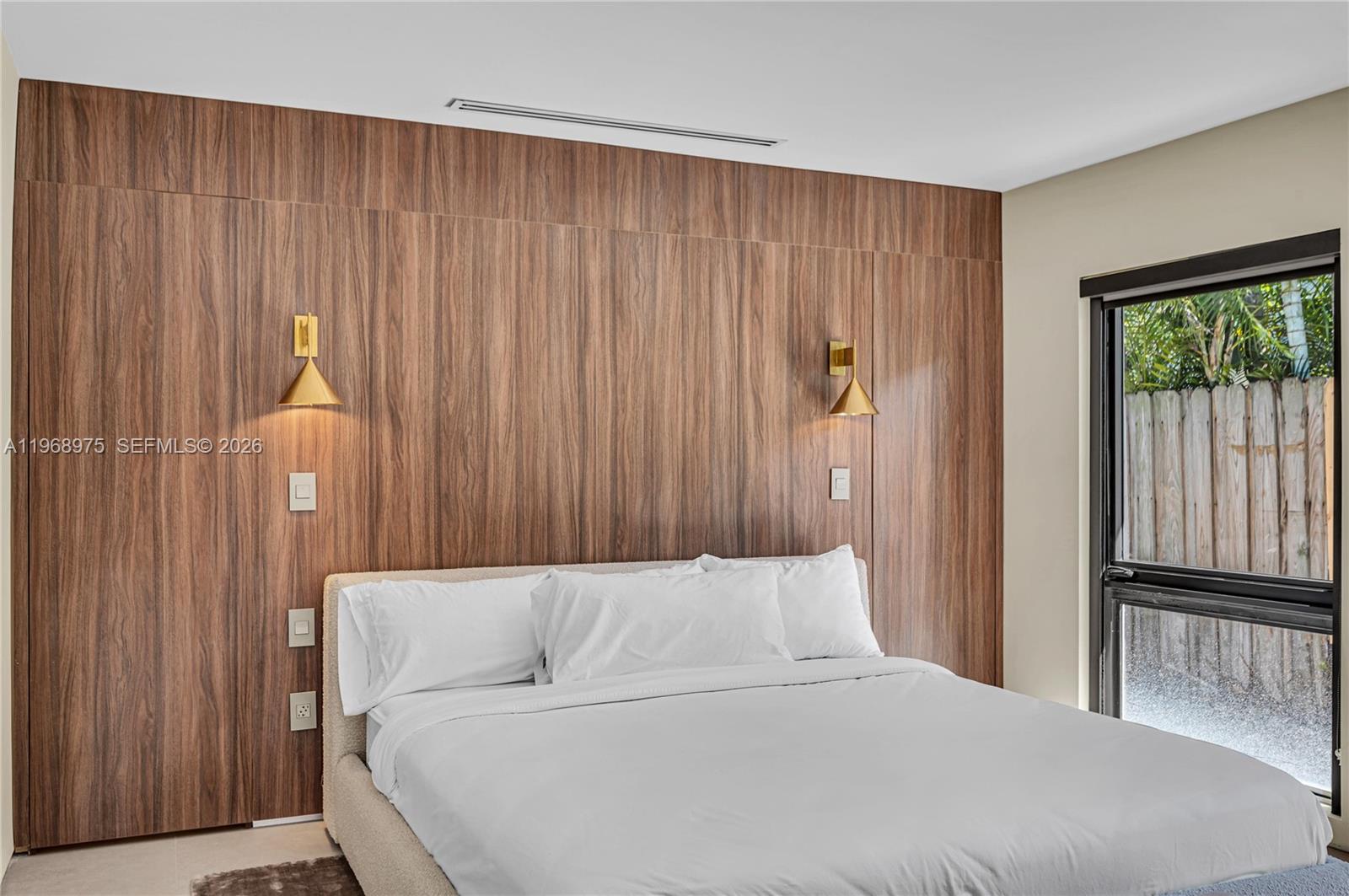 1170 South Biscayne Point Road Miami Beach, FL 33141 - Photo 29 of 48 a bedroom with a bed and a window