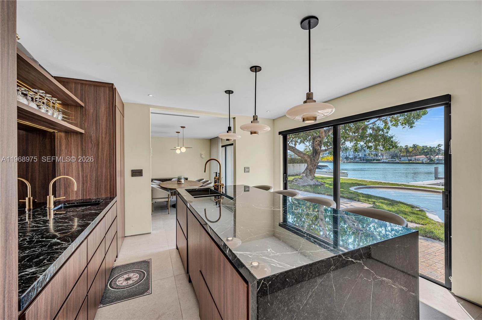 1170 South Biscayne Point Road Miami Beach, FL 33141 - Photo 3 of 48 a kitchen with a large window and stainless steel appliances