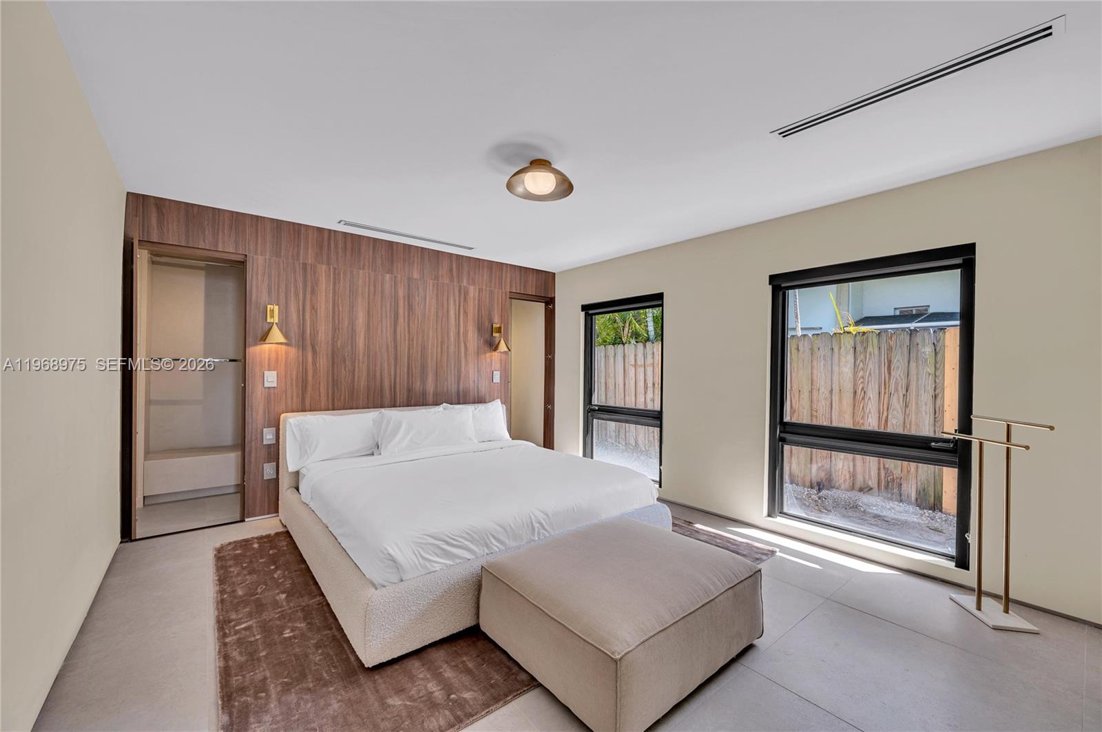 1170 South Biscayne Point Road Miami Beach, FL 33141 - Photo 31 of 48 a spacious bedroom with a bed and a window