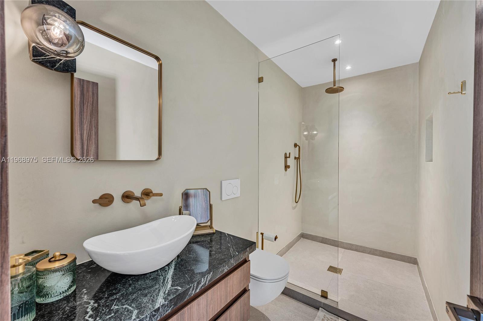 1170 South Biscayne Point Road Miami Beach, FL 33141 - Photo 32 of 48 a bathroom with a granite countertop sink mirror toilet and bathtub