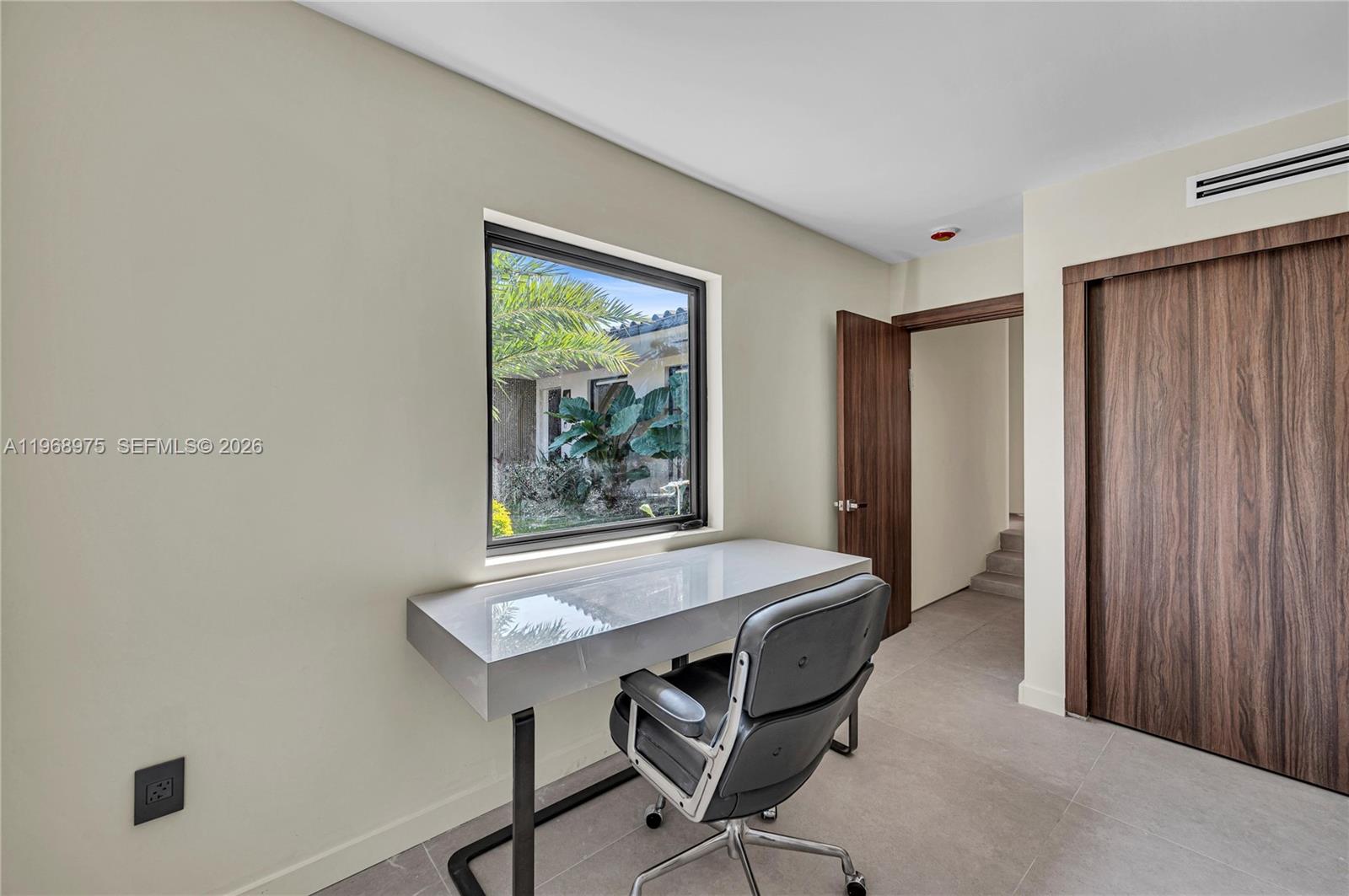 1170 South Biscayne Point Road Miami Beach, FL 33141 - Photo 37 of 48 a room with a table and chairs