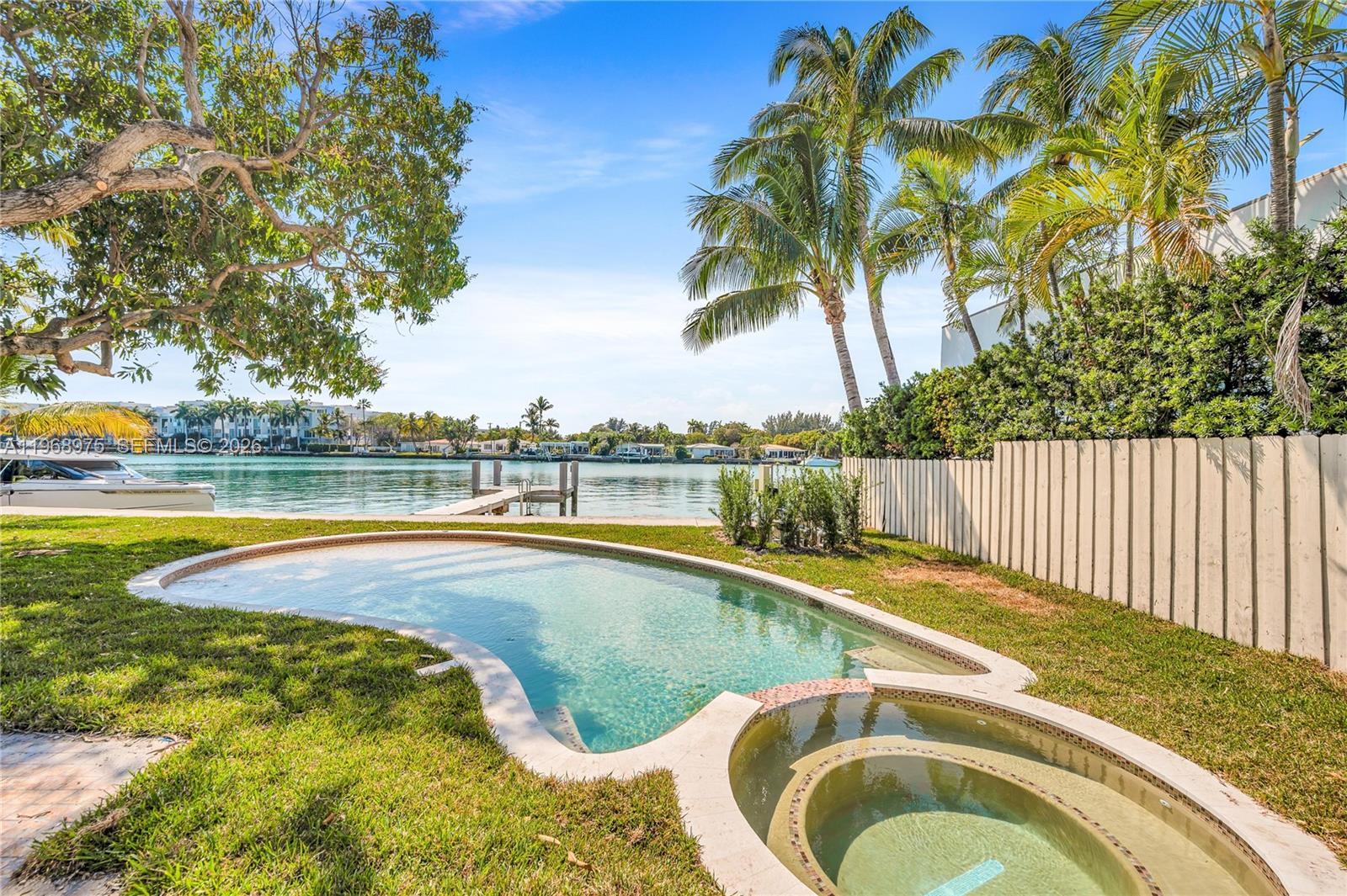 1170 South Biscayne Point Road Miami Beach, FL 33141 - Photo 46 of 48 a view of a swimming pool and a yard