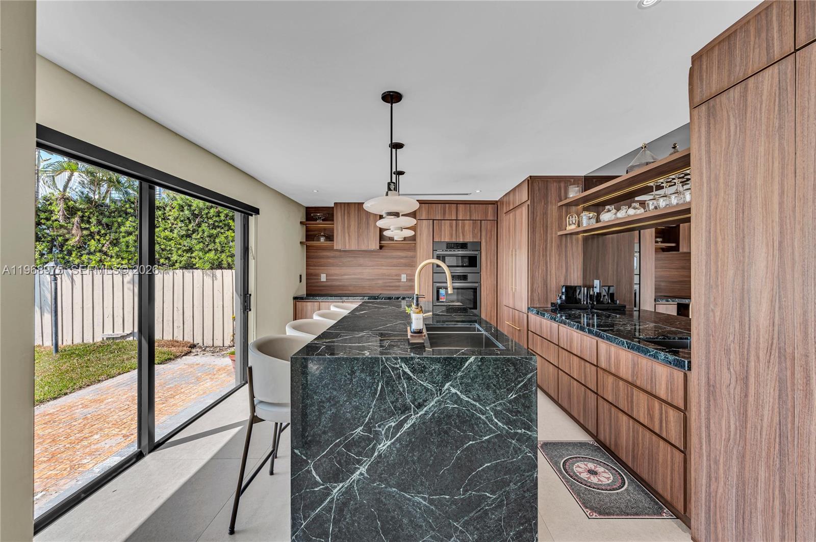 1170 South Biscayne Point Road Miami Beach, FL 33141 - Photo 5 of 48 a living room with furniture a flat screen tv and a large window
