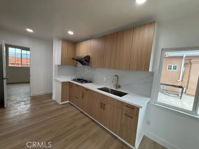 a kitchen with a sink window and cabinets