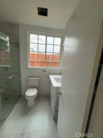 a bathroom with a toilet a sink and a shower